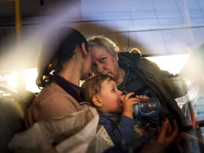 FILE - People with children wait after arriving from the Ukrainian city of Mariupol at a center for displaced people in Zaporizhzhia, Ukraine, May 3, 2022. With the evacuation of some civilians from a sprawling steel mill besieged by Russian forces, attention is turning to the fate of hundreds of Ukrainian troops still inside after weeks in the warren of underground tunnels and bunkers. (AP Photo/Evgeniy Maloletka, File)