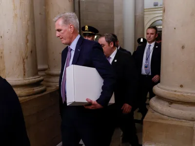 Former Speaker of the House Kevin McCarthy (R-CA) carries a box as he leaves the office of the Speaker of the House and heads out of the U.S. Capitol several hours after being ousted from the position of Speaker by a vote of the House of Representatives on Capitol Hill in Washington, U.S. October 3, 2023. REUTERS/Jonathan Ernst