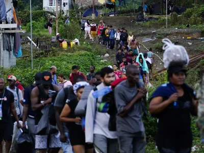 Migrants heading north line up to take a boat, in Bajo Chiquito, Darien province, Panama, Thursday, Oct. 5, 2023, after walking across the Darien Gap from Colombia. (AP Photo/Arnulfo Franco)