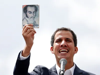 ﻿Juan Guaido, President of Venezuela's National Assembly, holds a copy of Venezuelan constitution during a rally against Venezuelan President Nicolas Maduro's government and to commemorate the 61st anniversary of the end of the dictatorship of Marcos Perez Jimenez in Caracas, Venezuela January 23, 2019. REUTERS/Carlos Garcia Rawlins