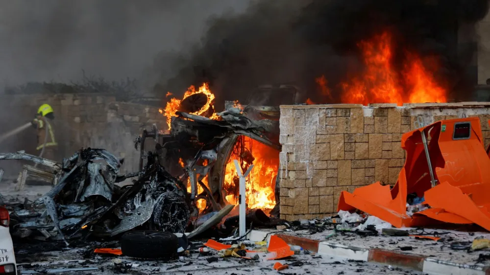 Objects burn on a road after rockets were launched from the Gaza Strip, in Ashkelon, Israel October 7, 2023. REUTERS/Amir Cohen