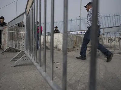 Israeli Border Police officers secure a checkpoint used by Palestinians to cross from the West Bank into Jerusalem, for the first Friday prayers in the Muslim holy month of Ramadan at the Al Aqsa mosque compound, Qalandia Israeli army checkpoint, west of Ramallah, Friday, April 8, 2022. (AP Photo/Nasser Nasser)