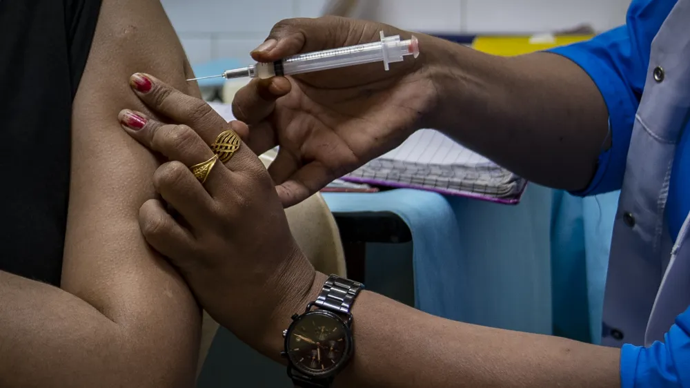 A girl receives the Corbevax vaccine for COVID-19 at a health centre in New Delhi, India, Wednesday, March 16, 2022. India is expanding its vaccination drive to include 12-14 year-old children. (AP Photo/Altaf Qadri)