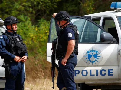 Police officers stand guard in the aftermath of a shooting, near the village of Zvecane, Kosovo September 24, 2023. REUTERS/Ognen Teofilovski