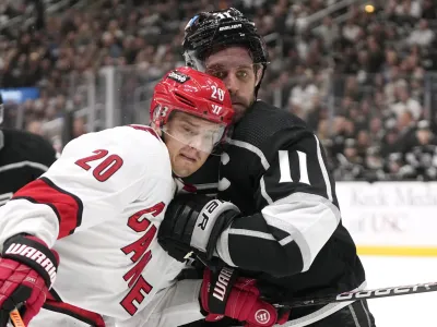 Carolina Hurricanes center Sebastian Aho, left, and Los Angeles Kings center Anze Kopitar battle for the puck during the third period of an NHL hockey game Saturday, Oct. 14, 2023, in Los Angeles. (AP Photo/Mark J. Terrill)