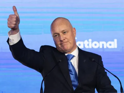 New Zealand National Party leader and Prime Minister elect Christopher Luxon gestures to supporters at a party event in Auckland, Saturday, Oct. 14, 2023, following a general election. (AP Photo/Brett Phibbs)