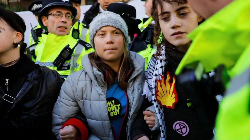 A police officer approaches Swedish climate campaigner Greta Thunberg during an Oily Money Out and Fossil Free London protest in London, Britain, October 17, 2023. REUTERS/Clodagh Kilcoyne