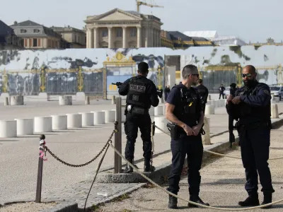 French police officers guard the entrance of the Chateau de Versailles after a security alert Tuesday, Oct. 17, 2023 in Versailles, west of Paris. The Palace of Versailles, one of France's most visited tourist attractions, is being evacuated for a security scare. It's the second time in four days the palace has had to close, with France on heightened alert against feared attacks after the fatal stabbing of a school teacher. (AP Photo/Christophe Ena)