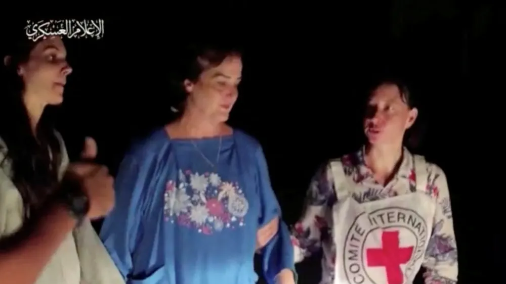 Judith Tai Raanan and her daughter Natalie Shoshana Raanan, U.S. citizens who were taken as hostages by Palestinian Hamas militants, are assisted by a Red Cross official after they were released by the militants, in response to Qatari mediation efforts, in Gaza Strip in this still picture taken from a video obtained by Reuters on October 21, 2023. Al-Qassam Brigade via Telegram/Handout via REUTERS THIS IMAGE HAS BEEN SUPPLIED BY A THIRD PARTY