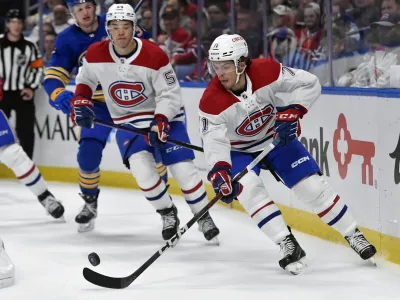 Montreal Canadiens center Jake Evans (71) skates with the puck during the second period of an NHL hockey game against the Buffalo Sabres in Buffalo, N.Y., Monday, Oct. 23, 2023. (AP Photo/Adrian Kraus)