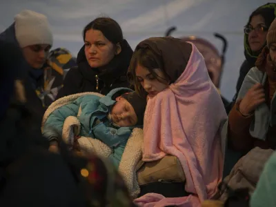 ﻿Refugees, mostly women with children, rest inside a tent after arriving at the border crossing, in Medyka, Poland on Sunday, March 6, 2022. (AP Photo/Visar Kryeziu)