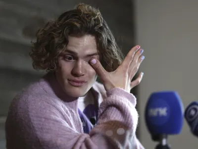 Norway's Lucas Braathen wipes his tears during a press conference in Soelden, Austria, Friday, Oct. 27, 2023. (AP Photo/Gabriele Facciotti)