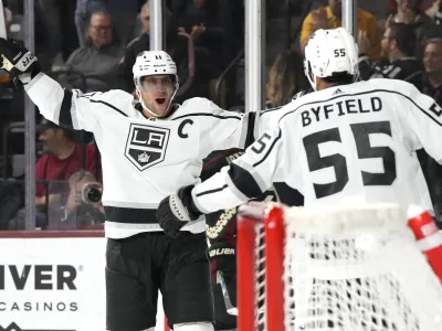 Los Angeles Kings center Anze Kopitar celebrates with center Quinton Byfield (55) after scoring a goal against the Arizona Coyotes during the third period of an NHL hockey game Friday, Oct. 27, 2023, in Tempe, Ariz. (AP Photo/Rick Scuteri)