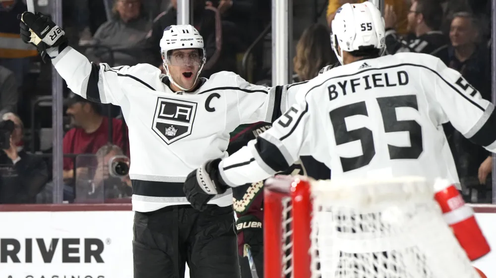 Los Angeles Kings center Anze Kopitar celebrates with center Quinton Byfield (55) after scoring a goal against the Arizona Coyotes during the third period of an NHL hockey game Friday, Oct. 27, 2023, in Tempe, Ariz. (AP Photo/Rick Scuteri)