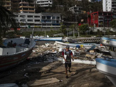 A fisherman arrives to a yacht club to join a rescue team in Acapulco, Mexico, Saturday, Oct. 28, 2023, in the aftermath of Hurricane Otis. (AP Photo/Felix Marquez)