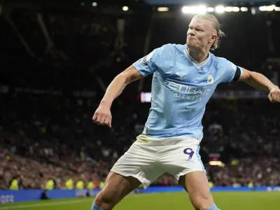 Manchester City's Erling Haaland celebrates after scoring his side's opening goal from a penalty kick during the English Premier League soccer match between Manchester United and Manchester City at Old Trafford stadium in Manchester, England, Sunday, Oct. 29, 2023. (AP Photo/Dave Thompson)