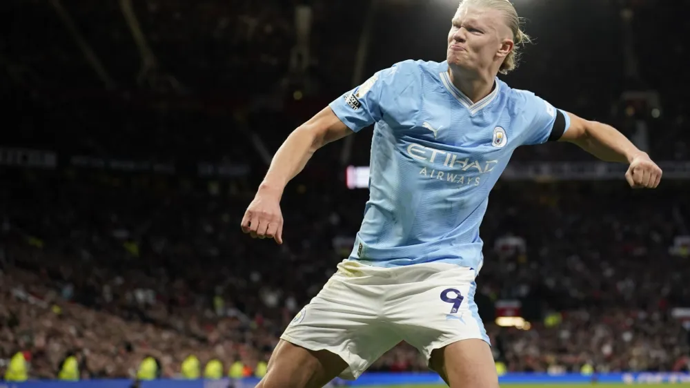 Manchester City's Erling Haaland celebrates after scoring his side's opening goal from a penalty kick during the English Premier League soccer match between Manchester United and Manchester City at Old Trafford stadium in Manchester, England, Sunday, Oct. 29, 2023. (AP Photo/Dave Thompson)