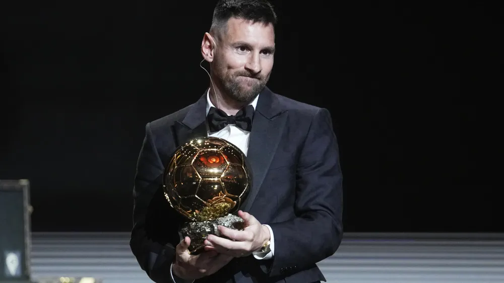 Inter Miami's and Argentina's national team player Lionel Messi receives the 2023 Ballon d'Or trophy during the 67th Ballon d'Or (Golden Ball) award ceremony at Theatre du Chatelet in Paris, France, Monday, Oct. 30, 2023. (AP Photo/Michel Euler)