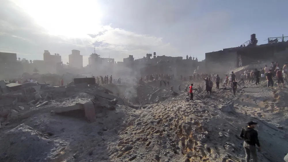 FILE - Palestinians inspect the damage of buildings destroyed by Israeli airstrikes on Jabaliya refugee camp on the outskirts of Gaza City on Oct. 31, 2023. In just 25 days of war, more than 3,600 Palestinian children have been killed in Gaza, according to Gaza's Hamas-run Health Ministry. The advocacy group Save The Children says more children were killed in Gaza in October 2023 than in all conflict zones around the world combined in 2022. (AP Photo/Abdul Qader Sabbah, File)