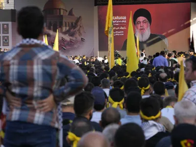 Supporters of the Iranian-backed Hezbollah group listen to Hezbollah leader Sayyed Hassan Nasrallah, who addresses a speech via a video link, during a rally to commemorate Hezbollah fighters who killed in South Lebanon last few weeks while fighting against the Israeli forces, in Beirut, Lebanon, Friday, Nov. 3, 2023. Nasrallah's speech had been widely anticipated throughout the region as a sign of whether the Israel-Hamas conflict would spiral into a regional war. (AP Photo/Hussein Malla)