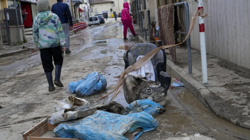 People walk in a flooded street of Campi di Bisenzio, in the central Italian Tuscany region, Friday, Nov. 3, 2023. Record-breaking rain provoked floods in a vast swath of Tuscany as storm Ciaran pushed into Italy overnight Friday, trapping people in their homes, inundating hospitals and overturning cars. At least three people were killed, and four were missing. (AP Photo/Gregorio Borgia)