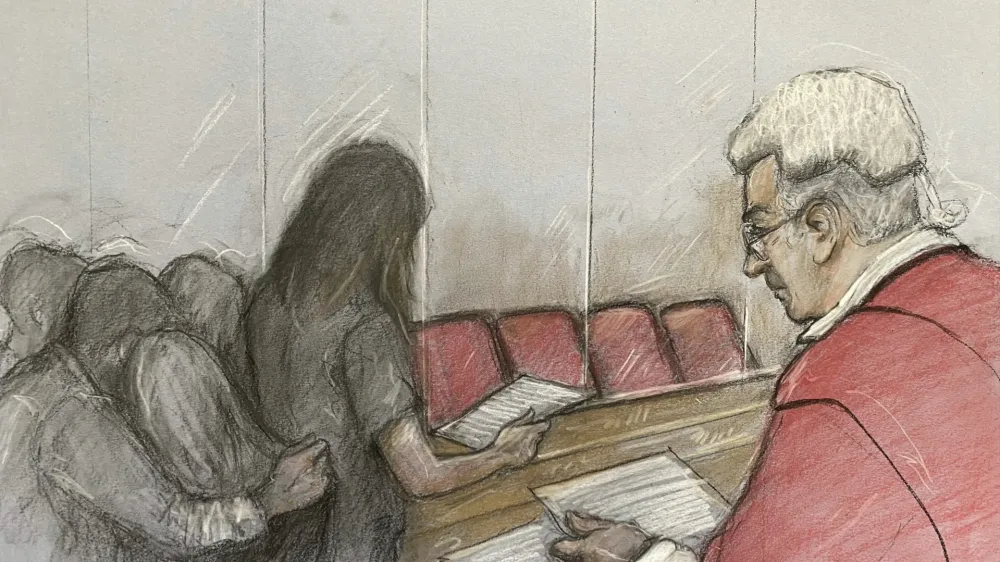 This court artist drawing by Elizabeth Cook of the parent of one of Lucy Letby's victims reading a victim impact statement at Manchester Crown Court in Manchester, England, Monday, Aug. 21, 2023. A judge is set to sentence Lucy Letby for murdering seven babies and attempting to kill six others while working as a neonatal nurse at a hospital in northern England. Justice James Goss on Monday could level the most severe sentence possible under British law by imposing a whole-life order to ensure that Letby will spend the rest of her life behind bars. (Elizabeth Cook/PA via AP)