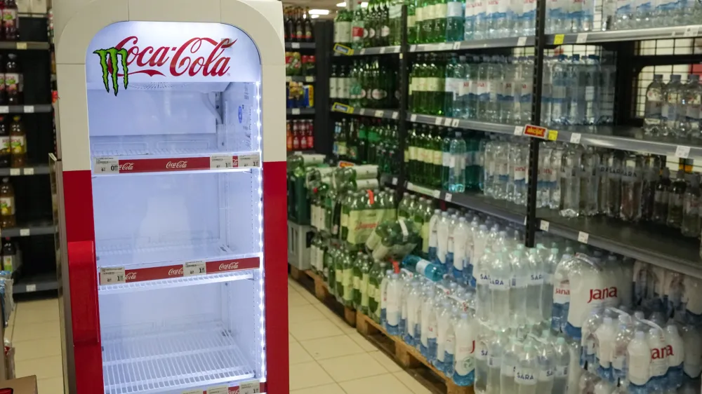 An empty CocaCola refrigerator is seen at a grocery shop in Zagreb, Croatia, Wednesday, Nov. 8, 2023. Authorities in Croatia on Wednesday recommended people drink only tap water as they investigated reports of several cases of people getting sick and suffering injuries allegedly after consuming bottled beverages. They did not say which products were being withdrawn, but photos on social media from shops suggested they were Coca-Cola brands. (AP Photo/Darko Bandic)