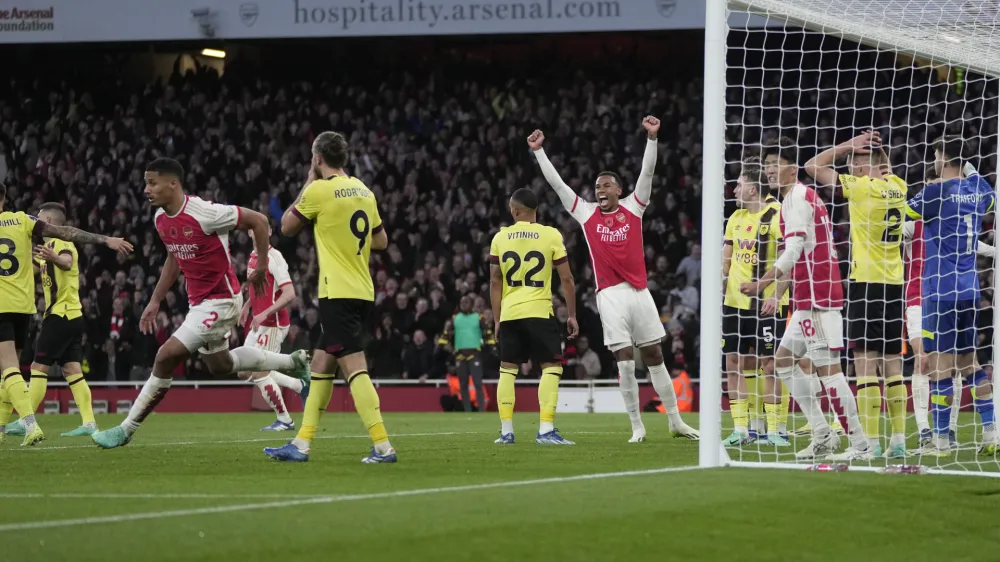 Arsenal's William Saliba, left, celebrates scoring his side's 2nd goal during the English Premier League soccer match between Arsenal and Burnley at Emirates stadium in London, England, Saturday, Nov. 11, 2023. (AP Photo/Kin Cheung)