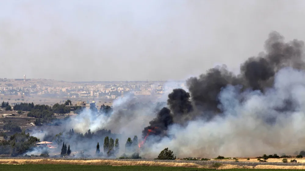 ﻿Smoke rises from a fire as a result of fighting in the the Syrian village of Quneitra near the border with Israel, as seen from an observatory near the Quneitra crossing, Thursday, June 6, 2013. Syrian rebels on Thursday captured a crossing point along a cease-fire line with Israel in the contested Golan Heights, a development that could deepen Israeli concerns over the growing role of Islamic radicals in the civil war near its northern frontier.(AP Photo/Sebastian Scheiner)