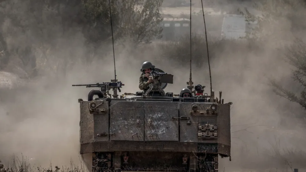 31 October 2023, Israel, Sderot: An Israeli armoured personnel carrier drives on the Gaza-Israel border amid ongoing conflict between Israel and the Palestinian group Hamas. According to eyewitness reports, Israeli tanks have been deployed on the central streets of Gaza City. Photo: Ilia Yefimovich/dpa