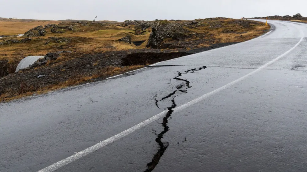 Cracks emerge on a road due to volcanic activity near a golf course, in Grindavik, Iceland November 11, 2023.  RUV/Ragnar Visage/Handout via REUTERS  THIS IMAGE HAS BEEN SUPPLIED BY A THIRD PARTY. NO RESALES. NO ARCHIVES. MANDATORY CREDIT