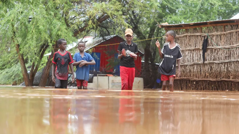 Somali children wade through flood water following heavy rains that have led the Juba river to overflow and flood large swathes of land in Dolow, Gedo region, Jubaland State of Somalia, November 12, 2023. REUTERS/Feisal Omar