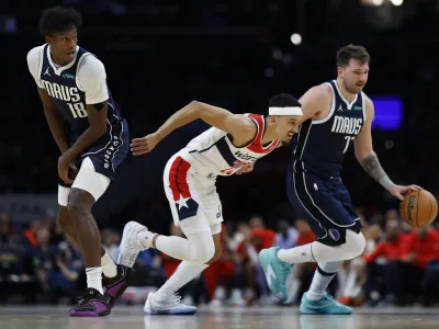 Nov 15, 2023; Washington, District of Columbia, USA; Dallas Mavericks guard Luka Doncic (77) dribbles the ball around screen by Mavericks forward Olivier-Maxence Prosper (18) as Washington Wizards guard Landry Shamet (20) defends in the second quarter at Capital One Arena. Mandatory Credit: Geoff Burke-USA TODAY Sports