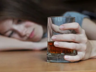 ﻿Drunk female with a glass of whiskey