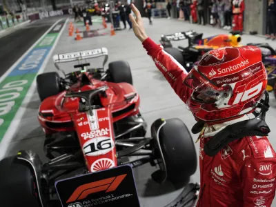 Ferrari driver Charles Leclerc, of Monaco, celebrates after winning the pole position during qualifications for the Formula One Las Vegas Grand Prix auto race, Saturday, Nov. 18, 2023, in Las Vegas. (AP Photo/John Locher)