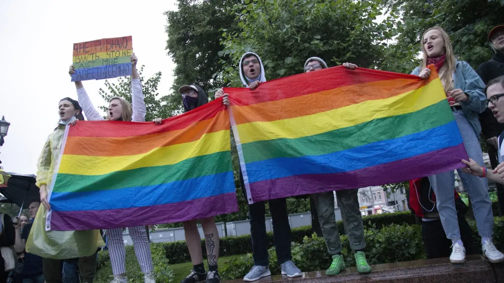 FILE - LGBT activists wave their flags during a rally to cancel the results of voting on amendments to the Constitution in Moscow, Russia, Wednesday, July 15, 2020. The Russian Justice Ministry says it has filed a lawsuit with the country's Supreme Court to outlaw the LGBTQ "international public movement" as extremist. (AP Photo, File)