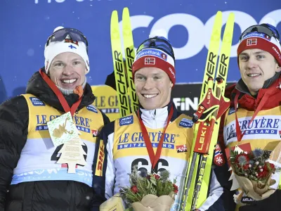 From left, second placed Iivo Niskanen of Finland, winner Martin L'wstr'm Nyenget of Norway and third placed Erik Valnes of Norway smile on the podium after the men's cross-country skiing 10 km classic style competition at the FIS World Cup Ruka Nordic Opening event in Kuusamo, Finland, Saturday, Nov. 25, 2023. (Heikki Saukkomaa/Lehtikuva via AP)