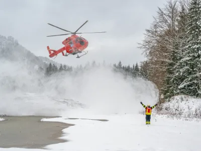 25 November 2023, Austria, Grünau Im Almtal: A helicopter lands near the accident site where a small plane crashed. All four occupants of a small aircraft have died in a crash in the mountains of northern Austria, authorities said. Photo: Team Fotokerschi.At / David Raus/APA/dpa