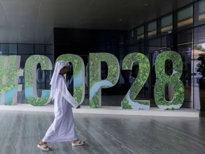 FILE PHOTO: A person walks past a "#COP28" sign in Abu Dhabi, United Arab Emirates, October 1, 2023. REUTERS/Amr Alfiky/File Photo