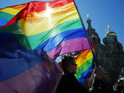 FILE - Gay rights activists carry rainbow flags as they march during a May Day rally in St. Petersburg, Russia, Wednesday, May 1, 2013. Russia's Supreme Court on Thursday, Nov. 30, 2023, effectively outlawed LGBTQ+ activism, in the most drastic step against advocates of gay, lesbian and transgender rights in the increasingly conservative country. (AP Photo, File)