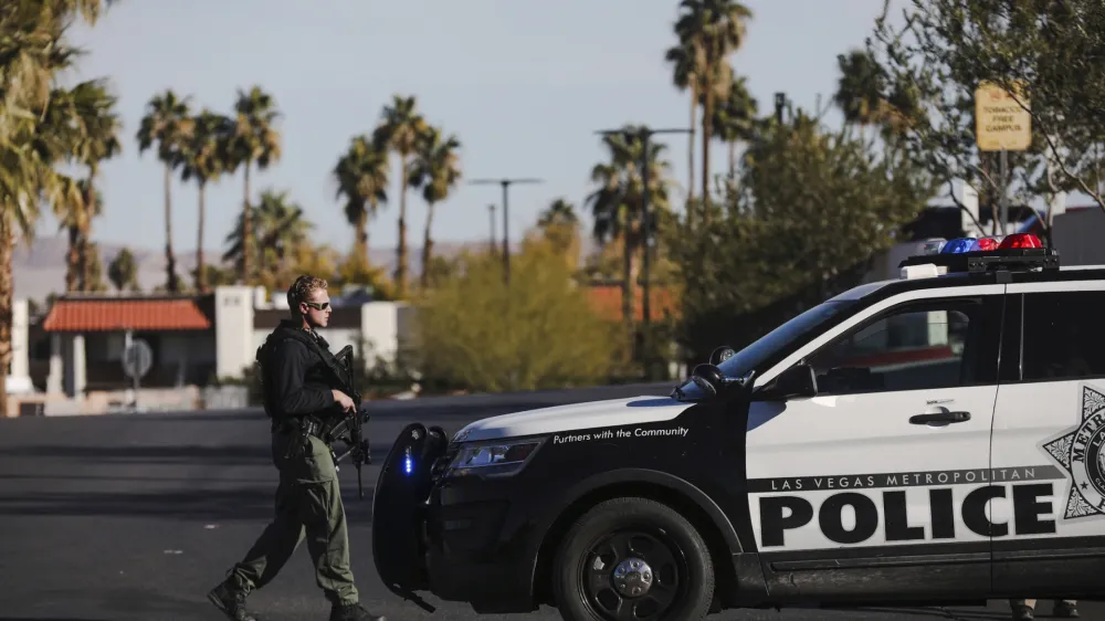 A police officer walks near Sunrise Hospital and Medical Center after a shooting at the University of Nevada, Las Vegas, campus, in Las Vegas, Wednesday, Dec. 6, 2023. (Rachel Aston/Las Vegas Review-Journal via AP)