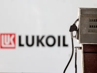 Model of petrol pump is seen in front of LUKOIL logo in this illustration taken March 25, 2022. REUTERS/Dado Ruvic/Illustration