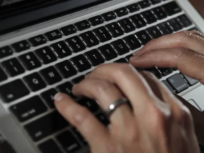 FILE- A person types on a laptop keyboard in North Andover, Mass, June 19, 2017. The U.S. government will restrict its use of commercial spyware tools that have been used to surveil human rights activists, journalists and dissidents around the world, under an executive order issued Monday, Oct. 27, 2023, by President Joe Biden. (AP Photo/Elise Amendola, File)