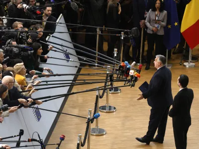 Hungary's Prime Minister Viktor Orban speaks with the media as he arrives for an EU summit at the European Council building in Brussels, Thursday, Dec. 14, 2023. European Union leaders, in a two-day summit will discuss the latest developments in Russia's war of aggression against Ukraine and continued EU support for Ukraine and its people. (AP Photo/Omar Havana)