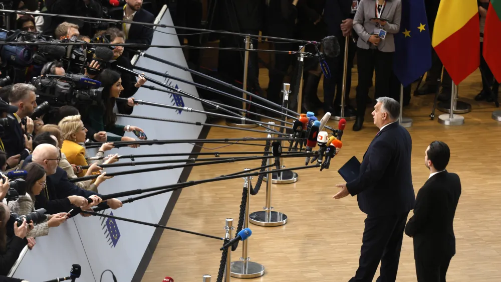 Hungary's Prime Minister Viktor Orban speaks with the media as he arrives for an EU summit at the European Council building in Brussels, Thursday, Dec. 14, 2023. European Union leaders, in a two-day summit will discuss the latest developments in Russia's war of aggression against Ukraine and continued EU support for Ukraine and its people. (AP Photo/Omar Havana)