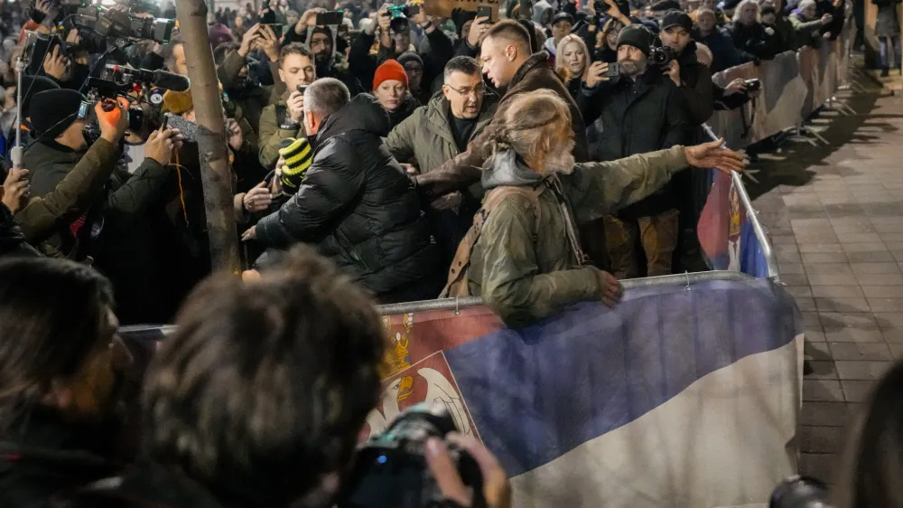 Serbian opposition supporters shout slogans during a protest joined by several thousand people, outside the country's electoral commission in Belgrade, Serbia, Monday, Dec. 18, 2023. An early official vote count of Serbia's weekend election on Monday confirmed victory for the ruling populist party in a parliamentary vote in the Balkan country, but political tensions rose over reported irregularities in the capital, Belgrade. (AP Photo/Darko Vojinovic)