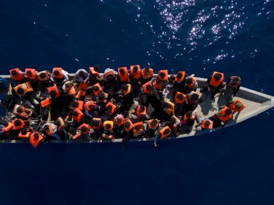 FILE - Migrants from Eritrea, Libya and Sudan sail a wooden boat before being assisted by aid workers of the Spanish NGO Open Arms, in the Mediterranean sea, about 30 miles north of Libya, Saturday, June 17, 2023. Ministers from Germany and France tasked with regulating migration are joining forces to try to curb deaths on dangerous routes across the Mediterranean Sea. The interior ministers are traveling Sunday for talks with the president and their counterpart in Tunisia, a major North African stepping stone for migrants trying to reach Europe at risk of their lives. (AP Photo/Joan Mateu Parra, File)