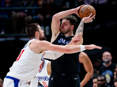 Dec 20, 2023; Dallas, Texas, USA; Dallas Mavericks guard Luka Doncic (77) looks to pass as LA Clippers center Ivica Zubac (40) defends during the second half at American Airlines Center. Mandatory Credit: Kevin Jairaj-USA TODAY Sports