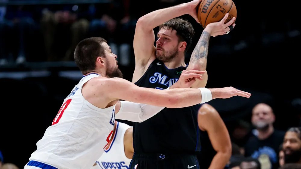 Dec 20, 2023; Dallas, Texas, USA; Dallas Mavericks guard Luka Doncic (77) looks to pass as LA Clippers center Ivica Zubac (40) defends during the second half at American Airlines Center. Mandatory Credit: Kevin Jairaj-USA TODAY Sports