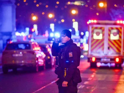 21 December 2023, Czech Republic, Prague: A police officer stands at the scene of a shooting in the building of the Faculty of Arts in central Prague. Photo: Deml Ondřej/CTK/dpa